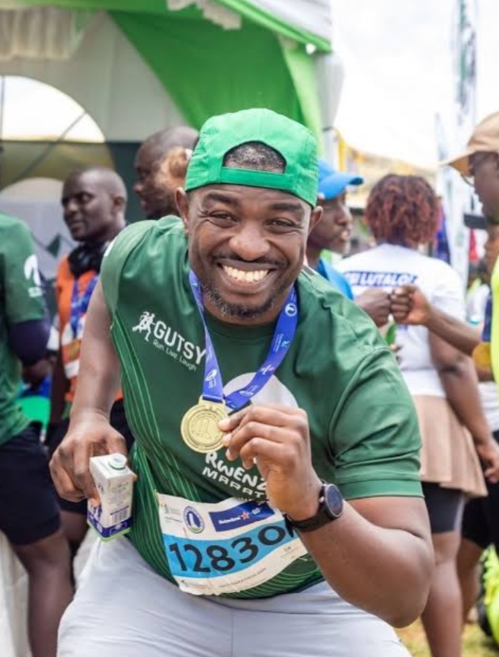 Madness in the Mountains: The Ultimate Mt. Rwenzori Marathon Guide & Where to Stay Happy male participant celebrating with his finisher medal in Kasese.
