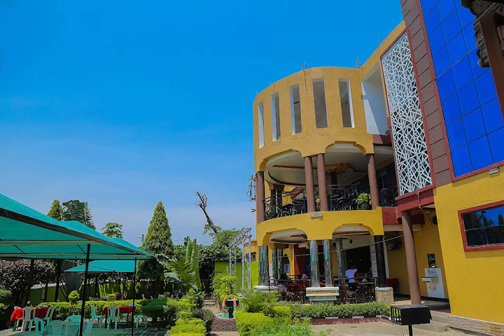 Madness in the Mountains: The Ultimate Mt. Rwenzori Marathon Guide & Where to Stay An exterior view of the gorgeous Kamwe Kamwe Hotel in the Heart of Kasese. The atmosphere is giving exotic.