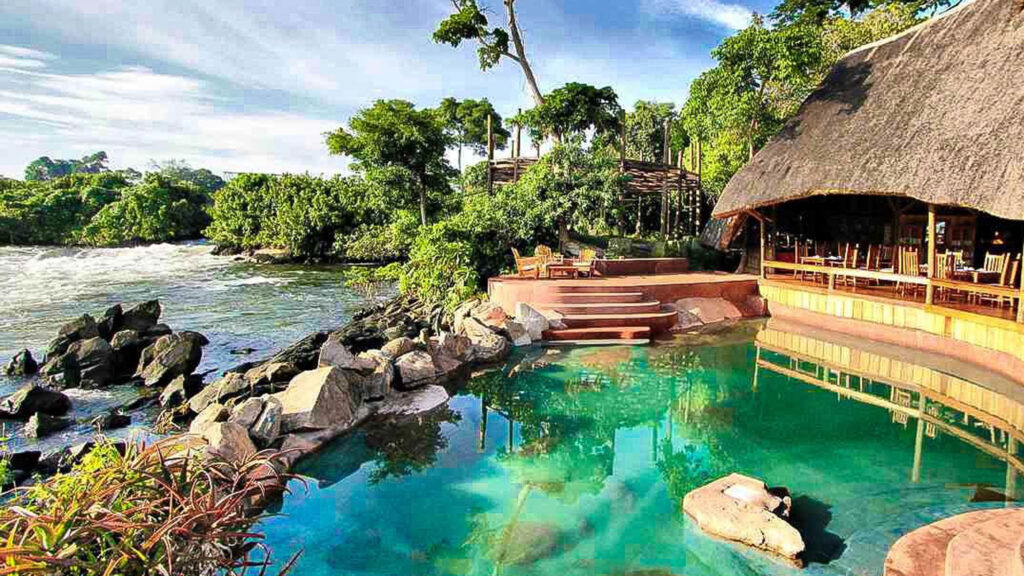Lemala Wild Waters Lodge Jinja: The Ultimate Private Island Retreat. The natural granite infinity pool at Lemala Wild Waters Lodge, seamlessly integrated into the rock peninsula of Kalagala Island with a direct view of the rushing Victoria Nile rapids.