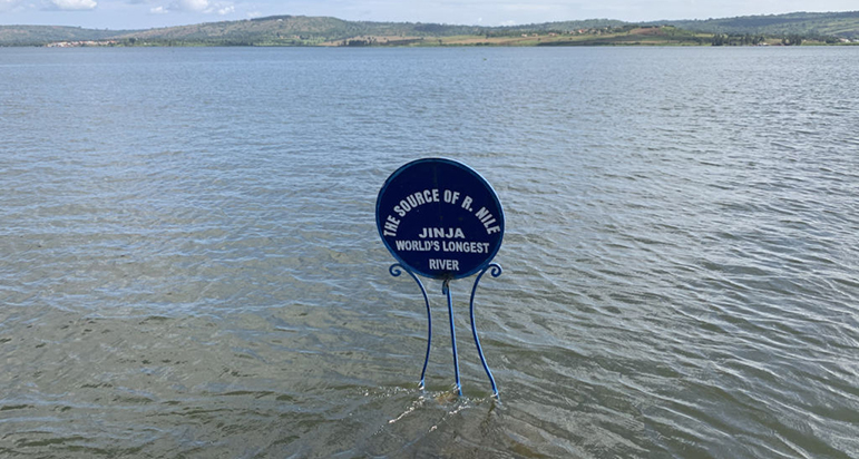 Jinja Adventure Guide 2026: 15 Insider Things to Do & Stays The iconic blue Source of the Nile monument sign submerged in water at the Zero Point in Jinja Uganda.
