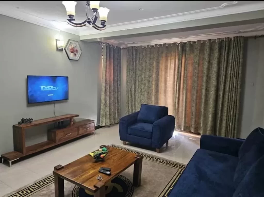 Bedroom room and DSTV setup at Kuza Suites, a top pick for where to stay in Mbale