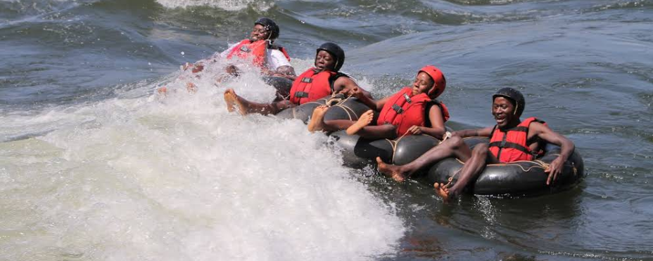 Jinja Adventure Guide 2026: 15 Insider Things to Do & Stays A group of friends laughing while extreme tubing through white water rapids on the Nile in Jinja.