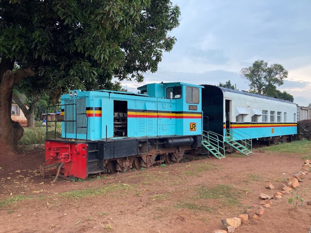 A vintage blue and white locomotive at the Uganda Railway Museum featured on a Jinja Uganda itinerary