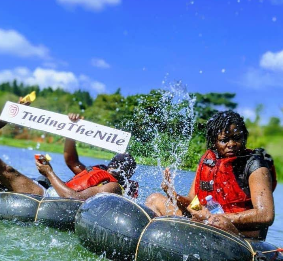 Travelers river tubing on the Nile with life jackets and splashing water during a custom Jinja Uganda itinerary